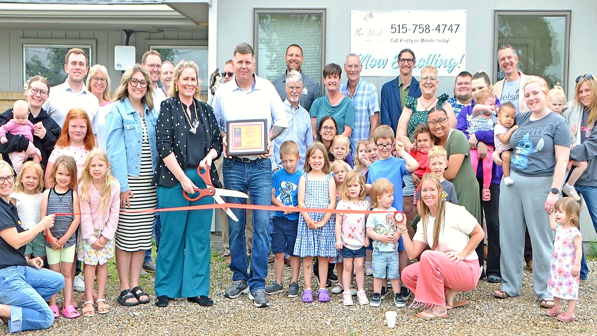 Families, children, and staff at The Nest Child Care and Early Learning Center ribbon cutting in Earlham, Iowa